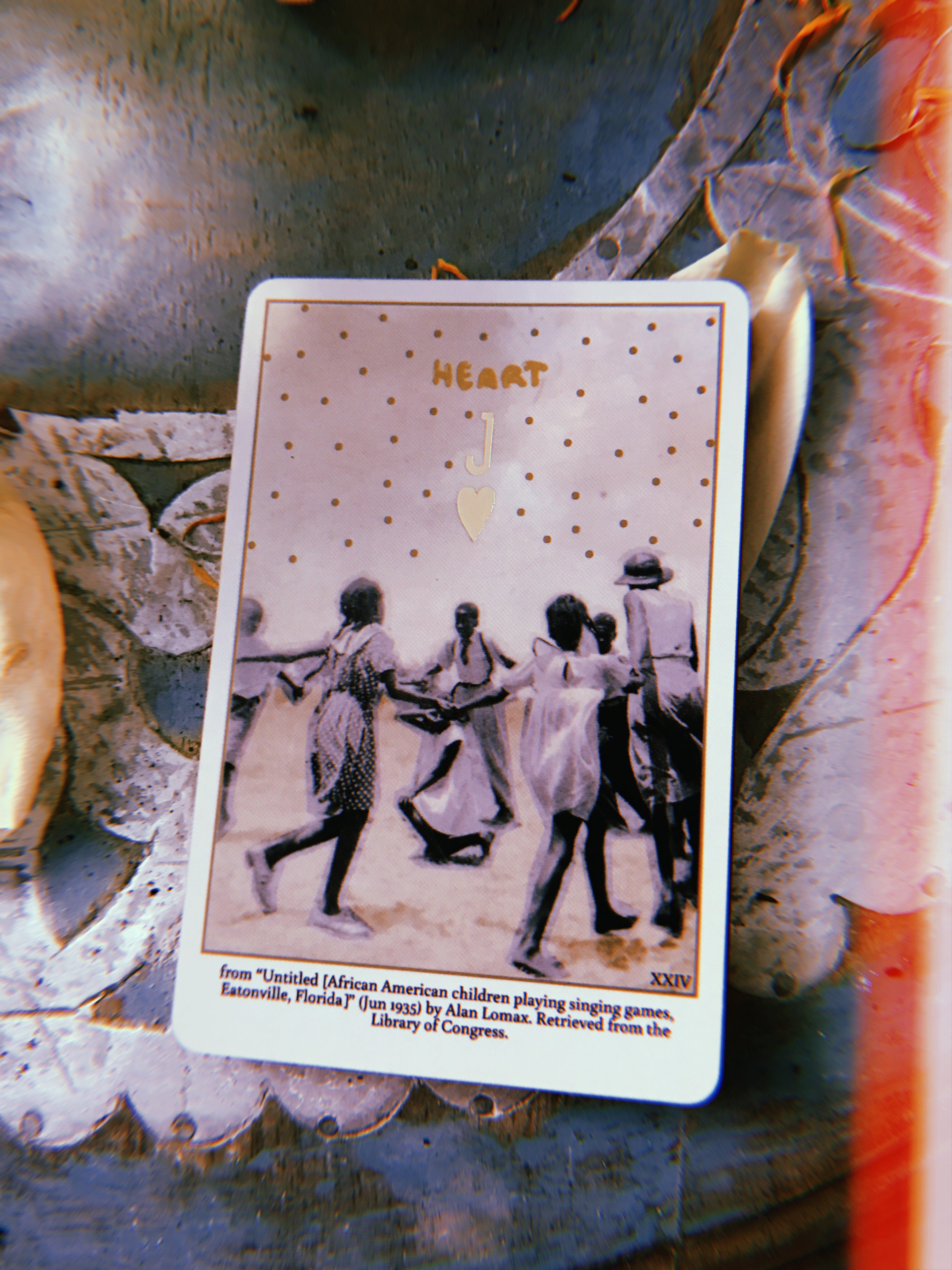 the Heart Card from Grandma Baby's Black Gold Lenormand deck, laying face up on a haint blue lazy susan