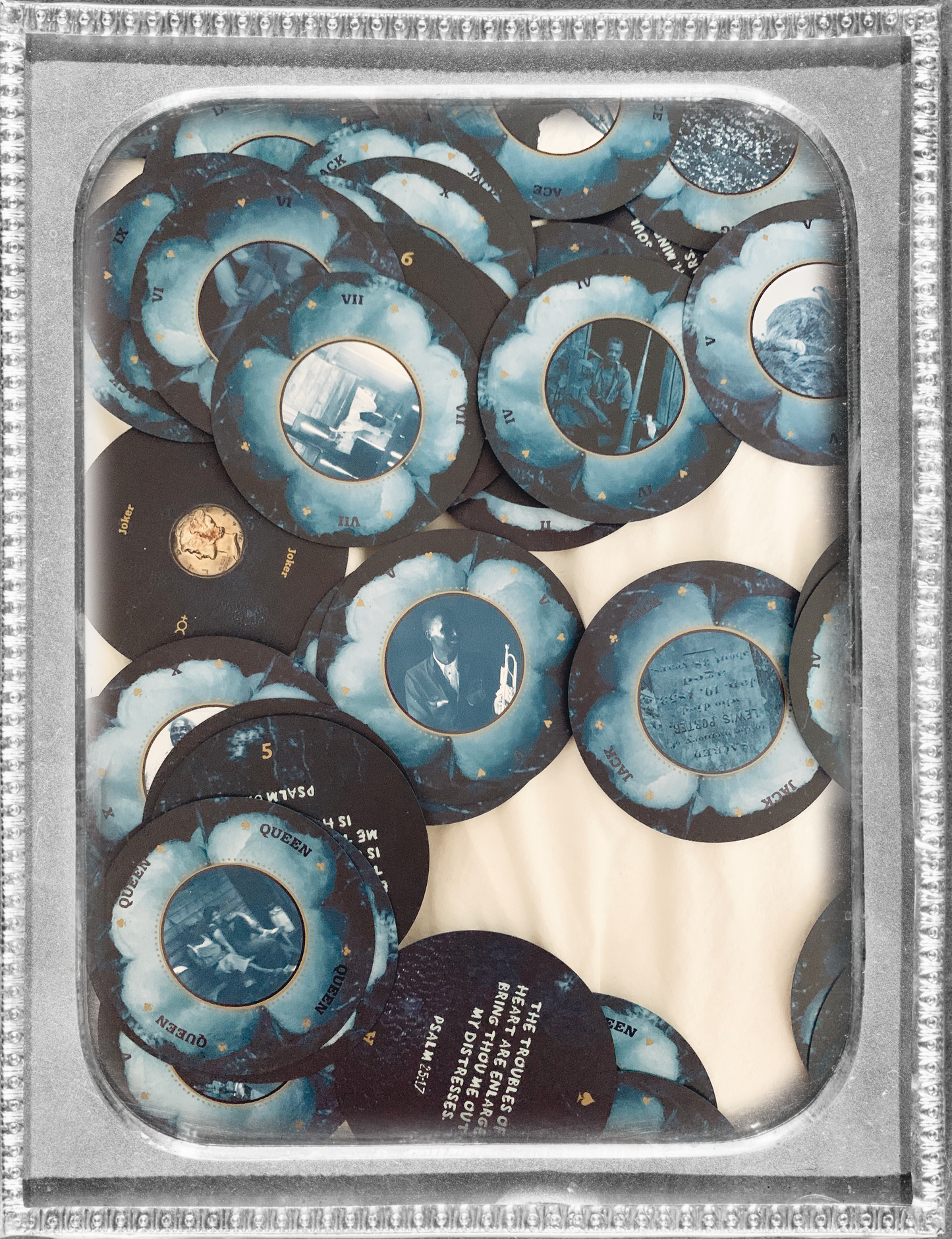 photo of Grandma Baby's 52 Blues Playing Cards scattered across a flat white sheet. photo is inside a silver vintage frame.