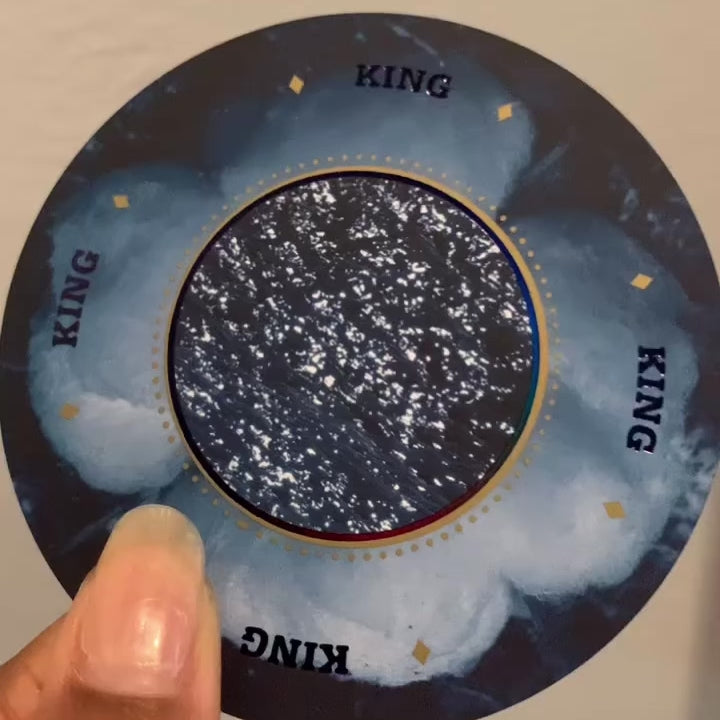 looping video of a brown hand turning the King of Diamonds card from Grandma Baby's 52 Blues to catch the light on the card face.